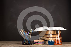 Education concept - books on the desk in the auditorium