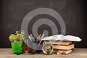 Education concept - books on the desk in the auditorium