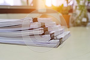 Stack of white paperwork achieves with black binder paper clips
