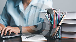 Education concept. Close up of female student make notes hand typing in laptop study online on computer from home. Woman typing in