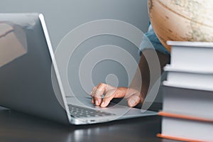 Education concept. Close up of female student make notes hand typing in laptop study online on computer from home. Woman typing in