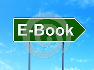 Education concept: E-Book on road sign background