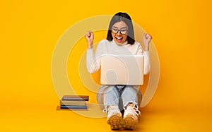 Education Concept. Happy Student Girl With Books And Laptop, Yellow Background