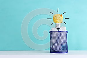 Education concept image. Creative idea and innovation. Crumpled paper as light bulb metaphor over blue background