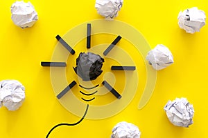 Education concept image. Creative idea and innovation. Crumpled paper as light bulb metaphor over yellow background