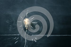 Education concept image. Creative idea and innovation. light bulb metaphor over blackboard background