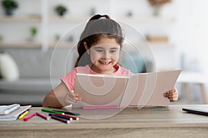 Education Concept. Portrait Of Cute Little Arab Girl Reading Book At Home