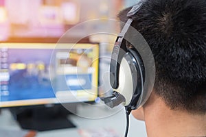 Education e-learning foreign languages Concept : Student Young man wearing Headphones listening English songs music and searching