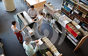 Education friendship people concept. Group of happy students learning together in college library