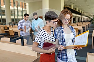 Education friendship people concept. Group of happy students learning together in college library