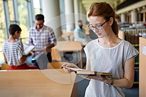 Education friendship people concept. Group of happy students learning together in college library