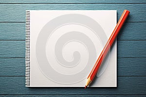 Education and goal setting concept notepad and red pencil arrangement