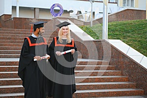 education, graduation and people concept - group of happy international students.