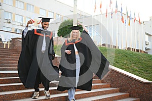 education, graduation and people concept - group of happy international students.