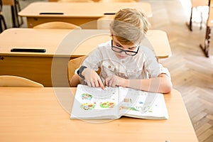 Education, high school, college. Portrait of a funny shouting student boy standing by a school blackboard