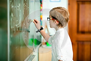 Education, high school, college. Portrait of a funny shouting student boy standing by a school blackboard