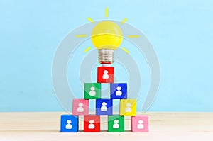 Education and human resource concept image. Creative idea and innovation. light bulb metaphor over blue background, wooden cubes