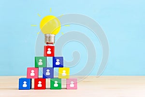 Education and human resource concept image. Creative idea and innovation. light bulb metaphor over blue background, wooden cubes