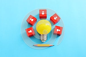 Education and human resource concept image. Creative idea and innovation. light bulb metaphor over blue background, wooden cubes