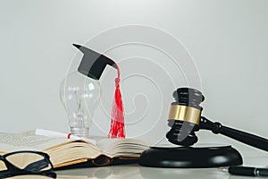 Education law concept.Scales of justice,law books,Graduation cap,light blub and book with white background.Justice legal and