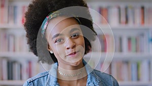 Education library, face and black woman with books shelf for university study, college learning or knowledge. Research