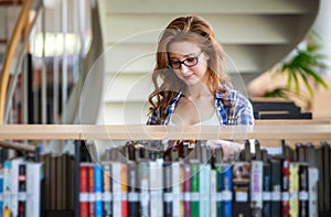 Education library high school university learning people concept. Smiling student girl reading book