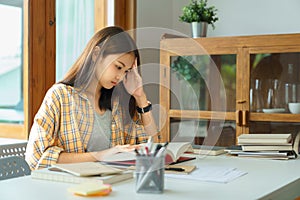 Education and literacy concept, College student girl feel confused while reading a book in library