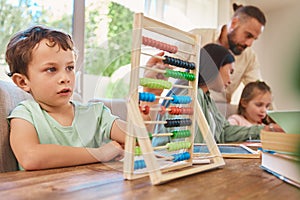 Education, mathematics and a boy counting on an abacus while learning in the living room of his home. Children, homework