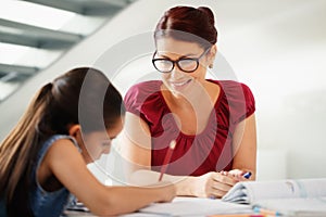 Education With Mom Helping Daughter Doing School Homework At Home