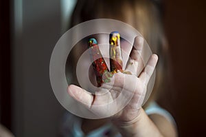 Education, school, art and painitng concept - little girl showing painted hands