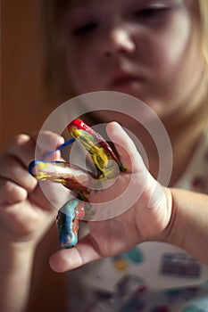 Education, school, art and painitng concept - little girl showing painted hands