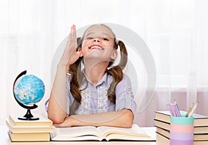 Education and school concept. Cute little student girl studying and raising hand