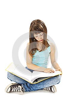 Education and school concept - little student girl sitting on floor and reading book