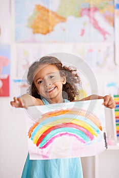 Education, school and portrait of girl with rainbow painting in a classroom for creative, learning or child development