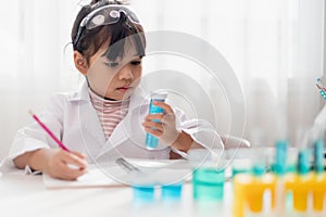 education, science, chemistry and children concept - kids or students with test tube making experiment at school laboratory