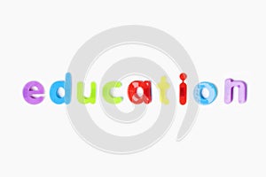 Education` spelled with colorful alphabet magnets over white background