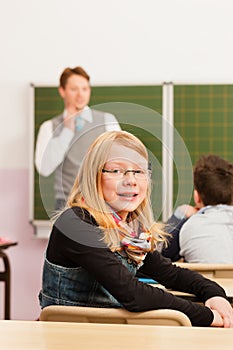 Education - Teacher with pupil in school teaching