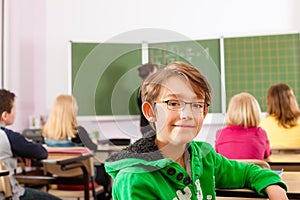 Education - teacher with pupil in school teaching