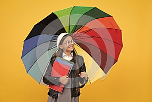 education. teen child under colorful parasol. kid in beret with rainbow umbrella. autumn season.
