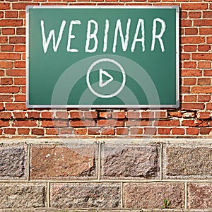 Education theme. Ancient brick wall with WEBINAR title on a chalkboard