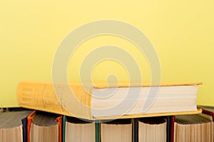 education and wisdom concept -books on wooden table, color background