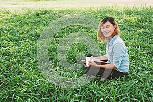 Education woman.Young beautiful woman reading a book in the park