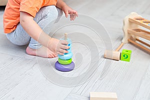 Education wooden toys. A child plays with wooden toys