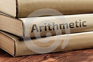 Educational books on arithmetic lie on a wooden table