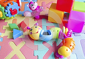 Educational children`s bright toys on the table. Puzzles, rattles, cubes and mechanical squirrel. Toys zero and older. Child`s