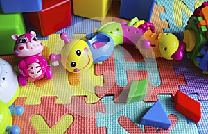 Educational children`s bright toys on the table. Puzzles, rattles, cubes and mechanical squirrel. Toys zero and older. Child`s