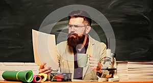 Educational concept. back to school. using microscope. biology education. serious bearded man hipster drink tea at