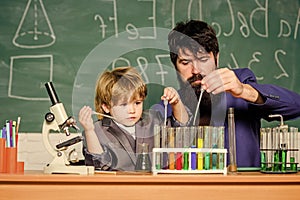 Educational concept. father and son at school. biology and chemistry education. Back to school. teacher man with little