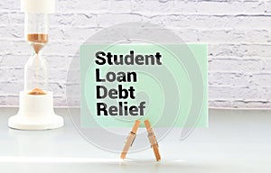 Educational concept with the inscription Student Loan Debt Relief in speech bubble on desk.