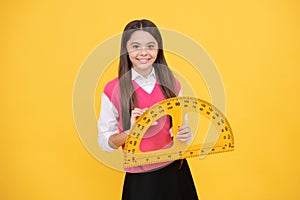 Educational concept. measurement. happy teenage girl with protractor. back to school.